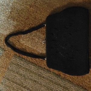 Beaded black evening bag with kiss lock.